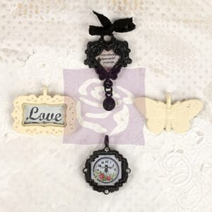 """Metal embellishments Lyric, measuring 1"""" to 1.5"""".